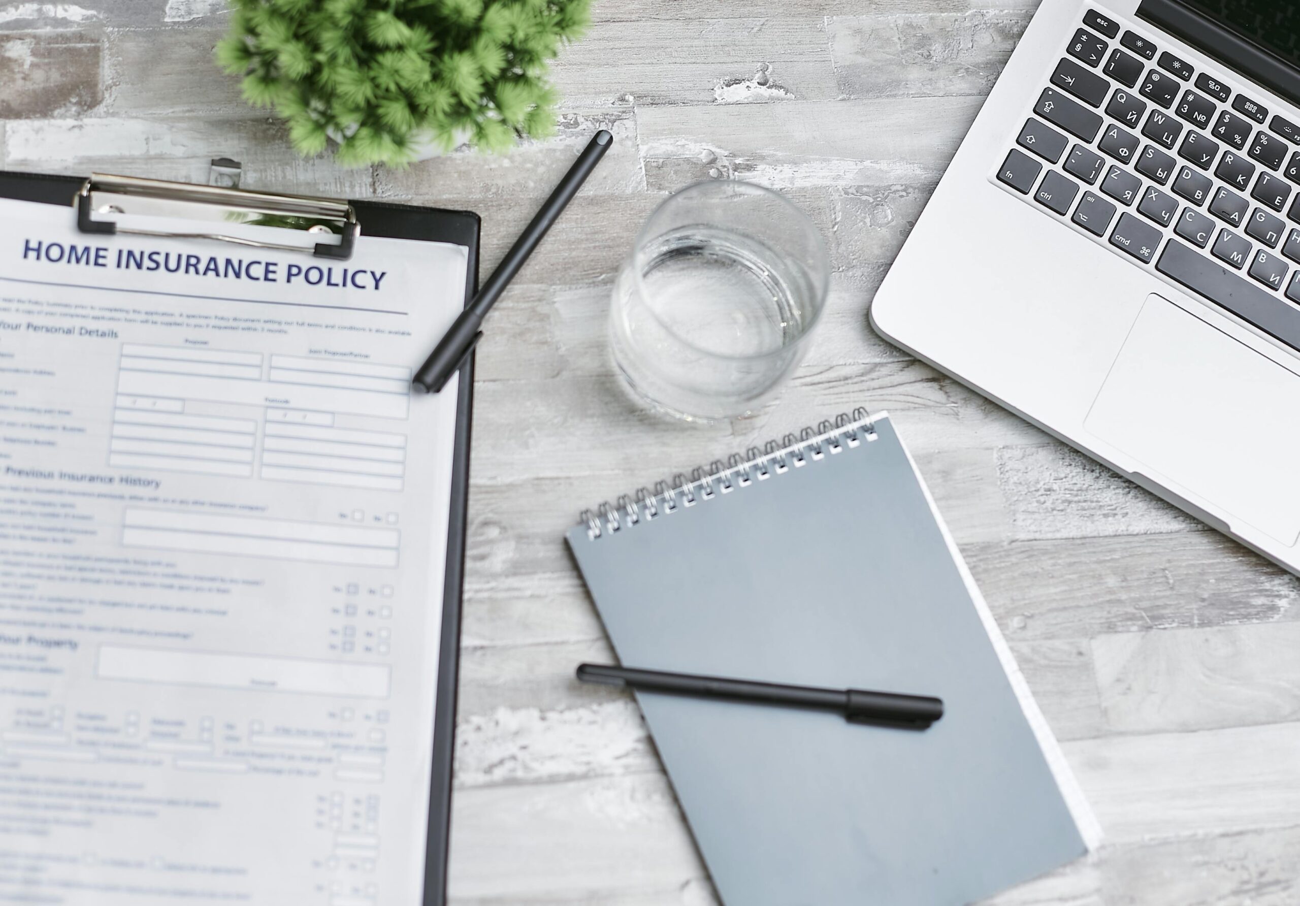A magnifying glass hovering over an insurance policy contract highlighting important clauses