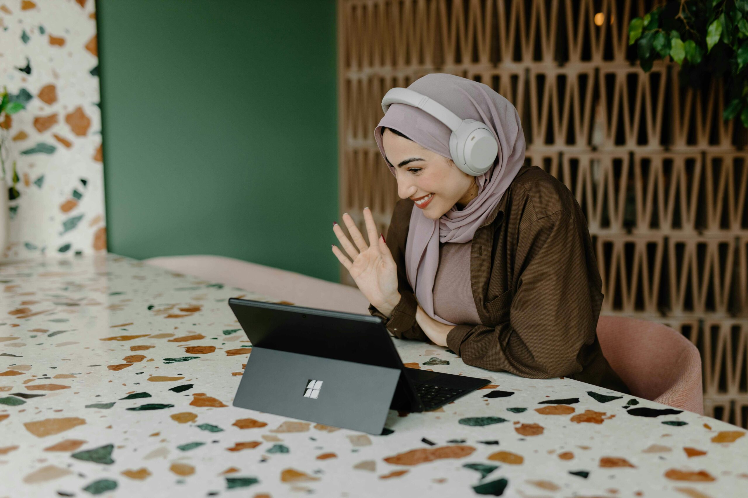 Sarah smiling beside her laptop after successful burglary insurance appeal