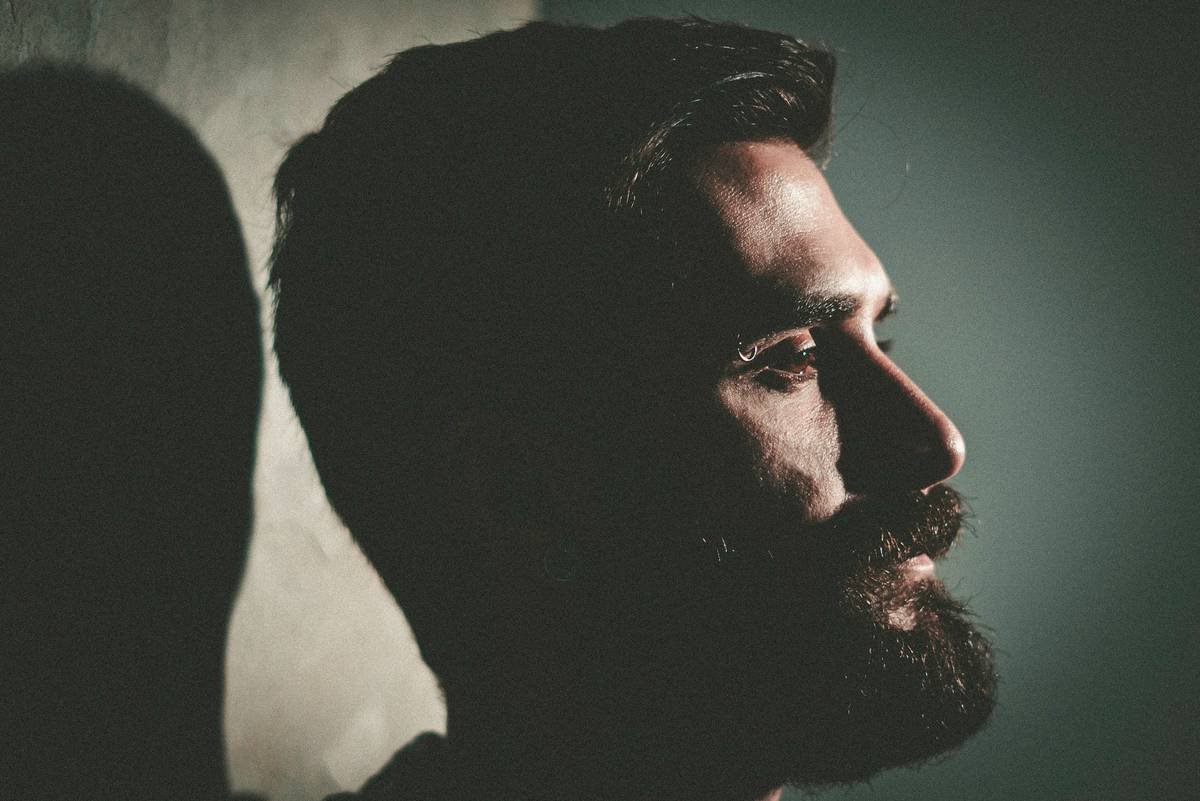Bearded man casts a shadow