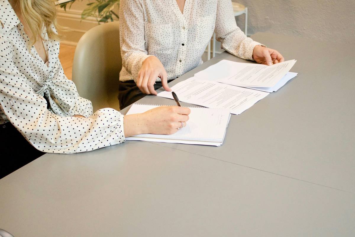 Homeowner reviewing coverage limit residential burglary c count documents with insurance agent
